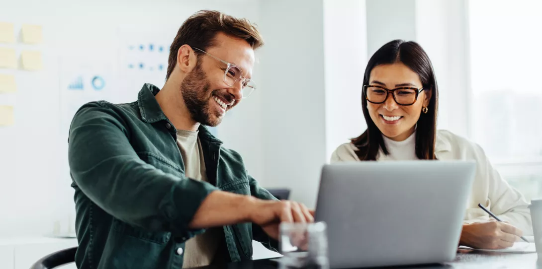 Woman and Man in front of laptop working together