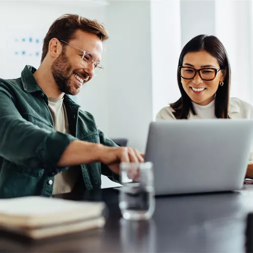 Woman and Man in front of laptop working together