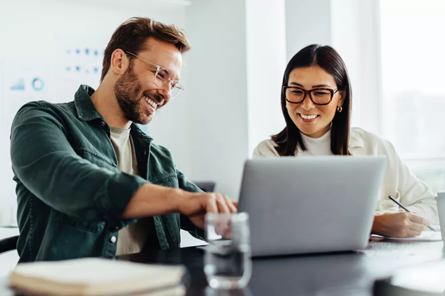 Woman and Man in front of laptop working together